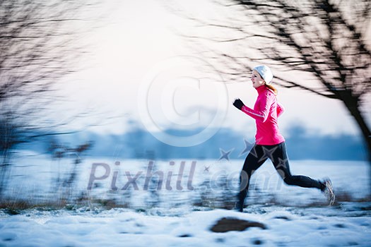 Winter running - Young woman running outdoors on a cold winter day (motion blurred image, color toned image) Winter running - Young woman running outdoors on a cold winter day (motion blurred image, color toned image)