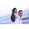 happy young romantic couple in love have fun on beautiful beach at beautiful summer day