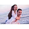 happy young romantic couple in love have fun on beautiful beach at beautiful summer day