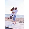 happy young romantic couple in love have fun on beautiful beach at beautiful summer day