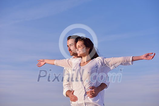 happy young romantic couple in love have fun on beautiful beach at beautiful summer day happy young romantic couple in love have fun on beautiful beach at beautiful summer day