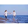 happy young romantic couple in love have fun on beautiful beach at beautiful summer day