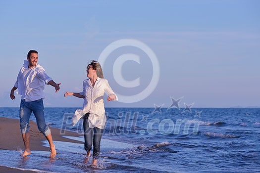 happy young romantic couple in love have fun on beautiful beach at beautiful summer day happy young romantic couple in love have fun on beautiful beach at beautiful summer day