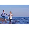 happy young romantic couple in love have fun on beautiful beach at beautiful summer day