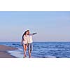 happy young romantic couple in love have fun on beautiful beach at beautiful summer day