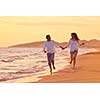 happy young romantic couple in love have fun on beautiful beach at beautiful summer day