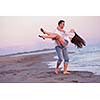 happy young romantic couple in love have fun on beautiful beach at beautiful summer day