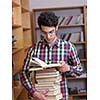 happy young teen boy in school on chemistry classes and library