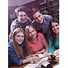 happy young teens group in school on chemisty lessons and library education