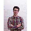 happy young teen boy in school on chemistry classes and library