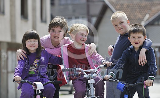 happy childrens group learning to drive bicycle outdoor at beautiful sunny spring day happy childrens group learning to drive bicycle outdoor at beautiful sunny spring day