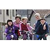 happy childrens group learning to drive bicycle outdoor at beautiful sunny spring day