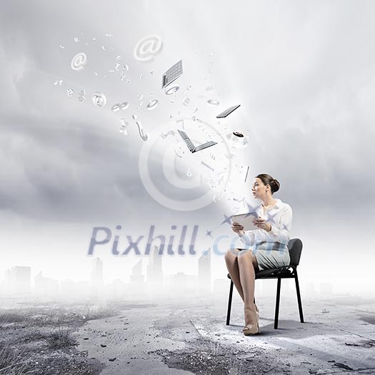 Image of businesswoman sitting on chair with tablet pc in hands Image of businesswoman sitting on chair with tablet pc in hands