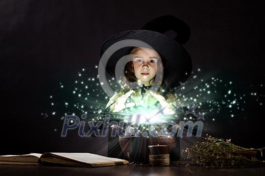 Little Halloween witch reading conjure above pot Little Halloween witch reading conjure above pot