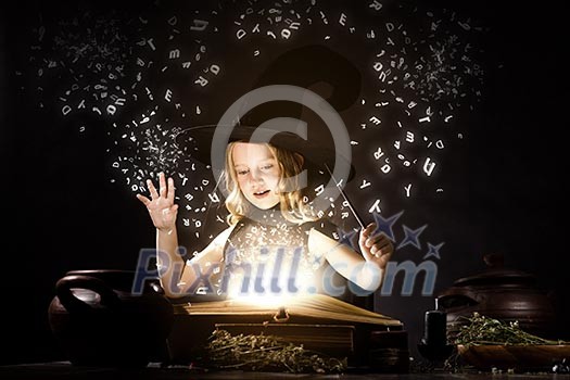 Little Halloween witch reading conjure from magic book Little Halloween witch reading conjure from magic book