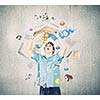 Young man in casual holding opened book with icons flying out