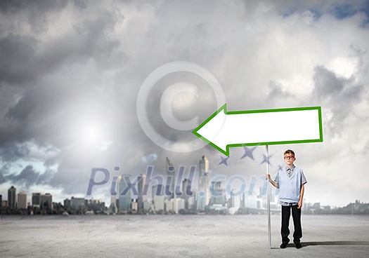 Boy of school age in glasses holding blank banner Boy of school age in glasses holding blank banner