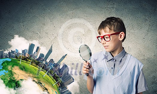 Cute school boy examining objects with magnifying glass. Elements of this image are furnished by NASA Cute school boy examining objects with magnifying glass. Elements of this image are furnished by NASA