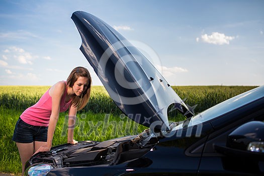 Pretty, young woman by the roadside after her car has broken down Pretty, young woman by the roadside after her car has broken down