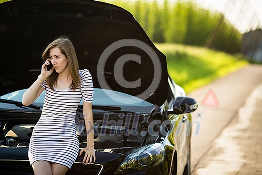 Pretty, young woman calling the roadside service/assistance after her car has broken down Pretty, young woman calling the roadside service/assistance after her car has broken down