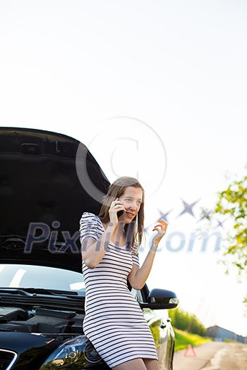 Pretty, young woman calling the roadside service/assistance after her car has broken down Pretty, young woman calling the roadside service/assistance after her car has broken down