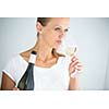 Gorgeous young woman with a glass of wine, smelling the lovely drink, savouring every sip (shallow DOF; color toned image)