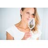 Gorgeous young woman with a glass of wine, smelling the lovely drink, savouring every sip (shallow DOF; color toned image)