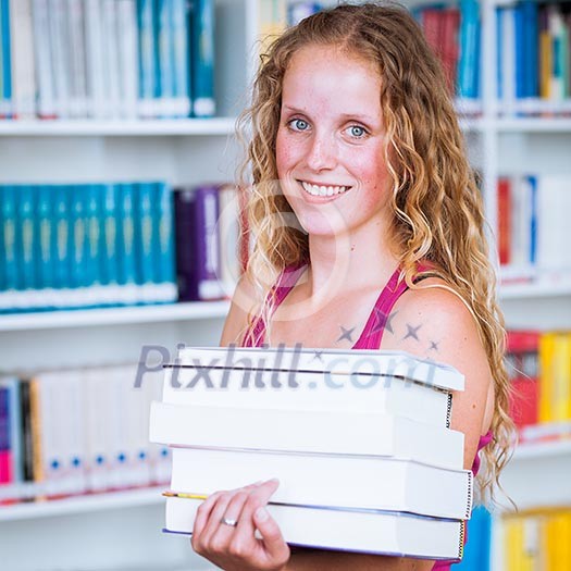 Pretty, young college student female college student in a library (shallow DOF; color toned image) Pretty, young college student female college student in a library (shallow DOF; color toned image)