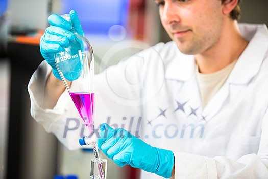Young male researcher carrying out scientific research in a lab (shallow DOF; color toned image) Young male researcher carrying out scientific research in a lab (shallow DOF; color toned image)