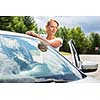 Young, attractive, happy woman standing by her car, being a proud  owner of her new vehicle