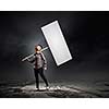 Young woman in casual carrying white blank banner