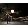 Young woman in casual holding road sign