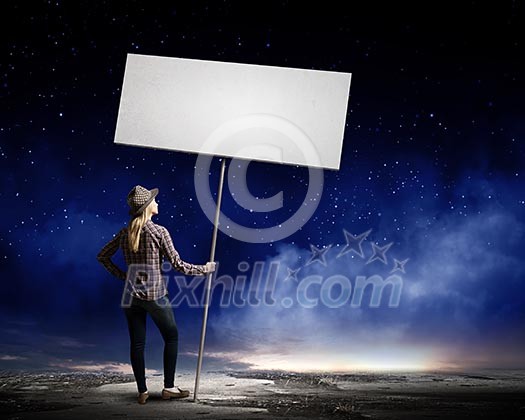 Young woman in casual carrying white blank banner Young woman in casual carrying white blank banner