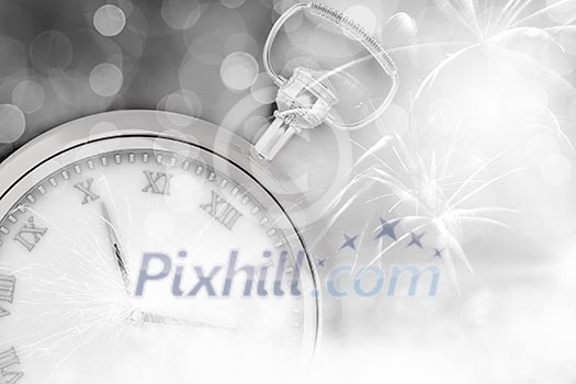 Conceptual image of clock with bokeh lights and firework Conceptual image of clock with bokeh lights and firework