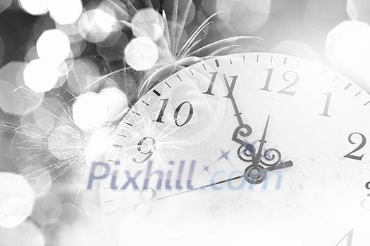 Conceptual image of clock with bokeh lights and firework Conceptual image of clock with bokeh lights and firework