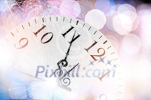 Conceptual image of clock with bokeh lights and firework Conceptual image of clock with bokeh lights and firework