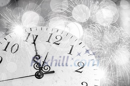 Conceptual image of clock with bokeh lights and firework Conceptual image of clock with bokeh lights and firework