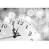 Conceptual image of clock with bokeh lights and firework