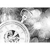 Conceptual image of clock with bokeh lights and firework