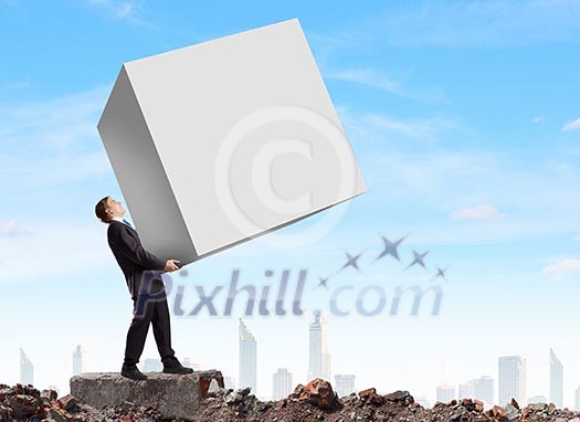 Young businessman carrying white blank cube. Place for text Young businessman carrying white blank cube. Place for text