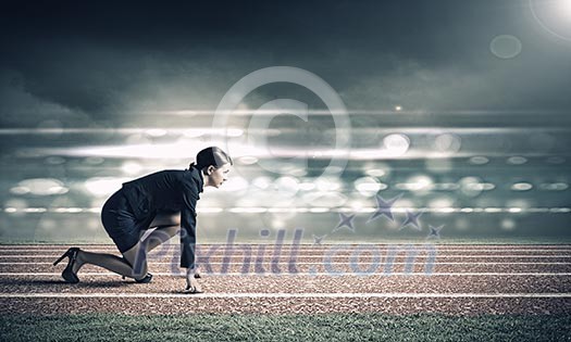 Side view of businesswoman in suit ready to run Side view of businesswoman in suit ready to run
