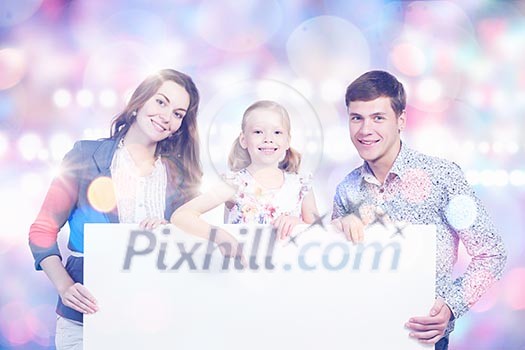 Young happy family with white blank banner. Place for text Young happy family with white blank banner. Place for text