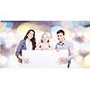 Young happy family with white blank banner. Place for text