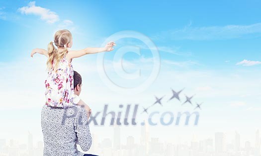 Little daughter sitting on father's shoulders. Parenting concept Little daughter sitting on father's shoulders. Parenting concept