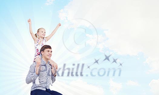 Little daughter sitting on father's shoulders. Parenting concept Little daughter sitting on father's shoulders. Parenting concept