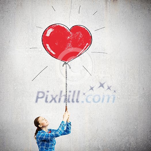 Young woman in casual holding heart shaped balloon Young woman in casual holding heart shaped balloon