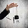 Close up of male hand holding items on rope