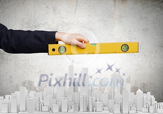 Close up of female hand measuring construction project with ruler Close up of female hand measuring construction project with ruler