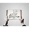 Close up of businessman hands holding opened notepad with sketches