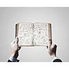 Close up of businessman hands holding opened notepad with sketches